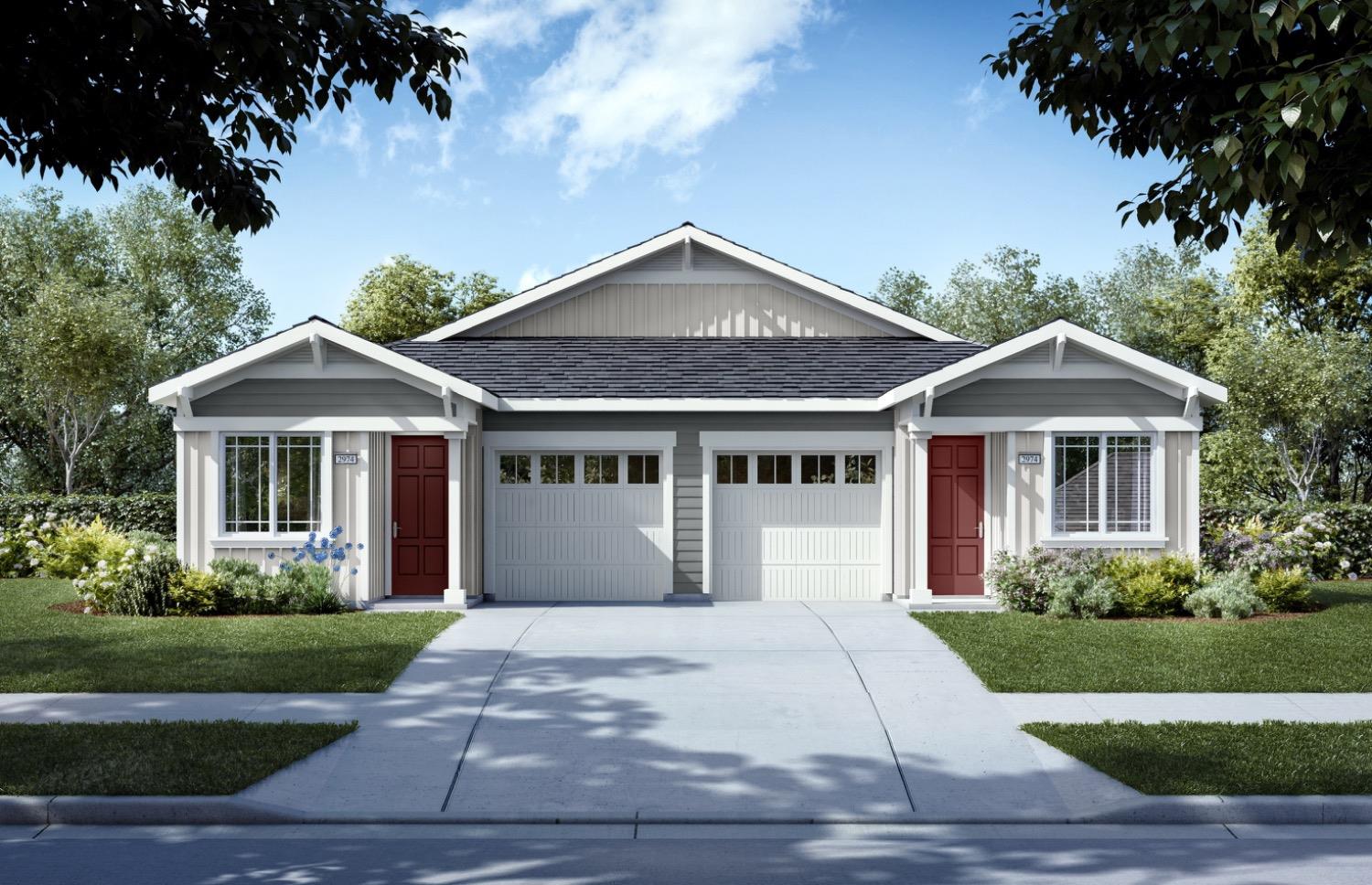 a front view of a house with yard and green space