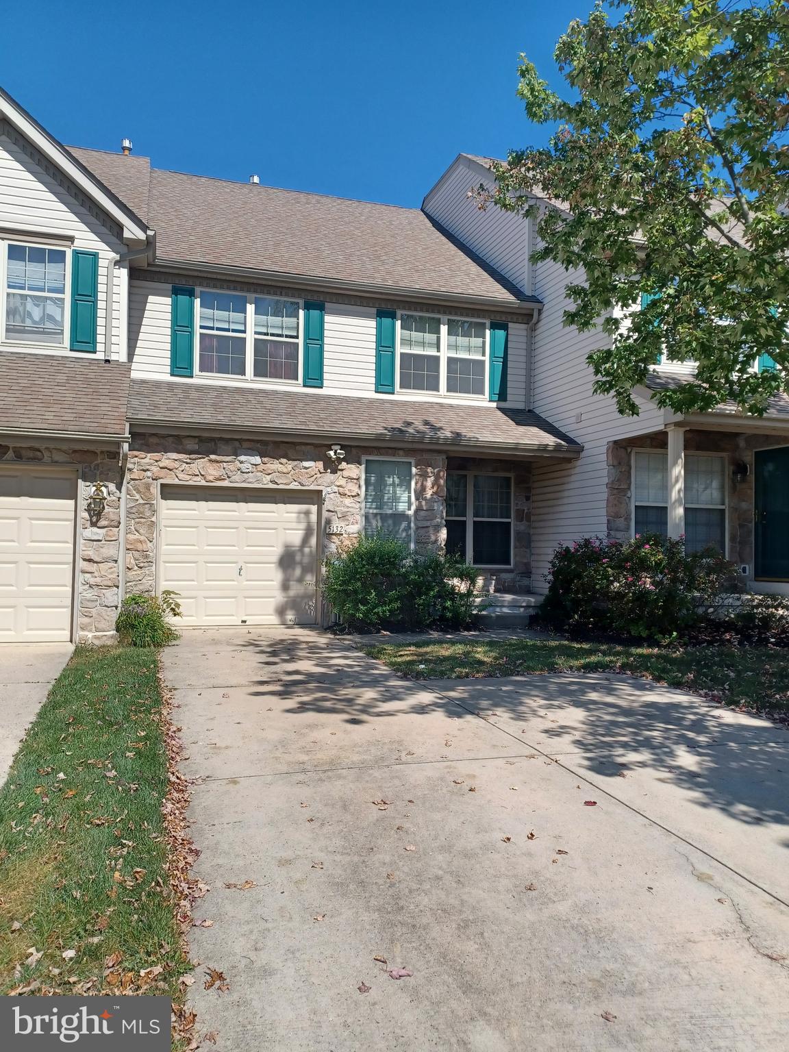 a front view of a house with a yard and a garage