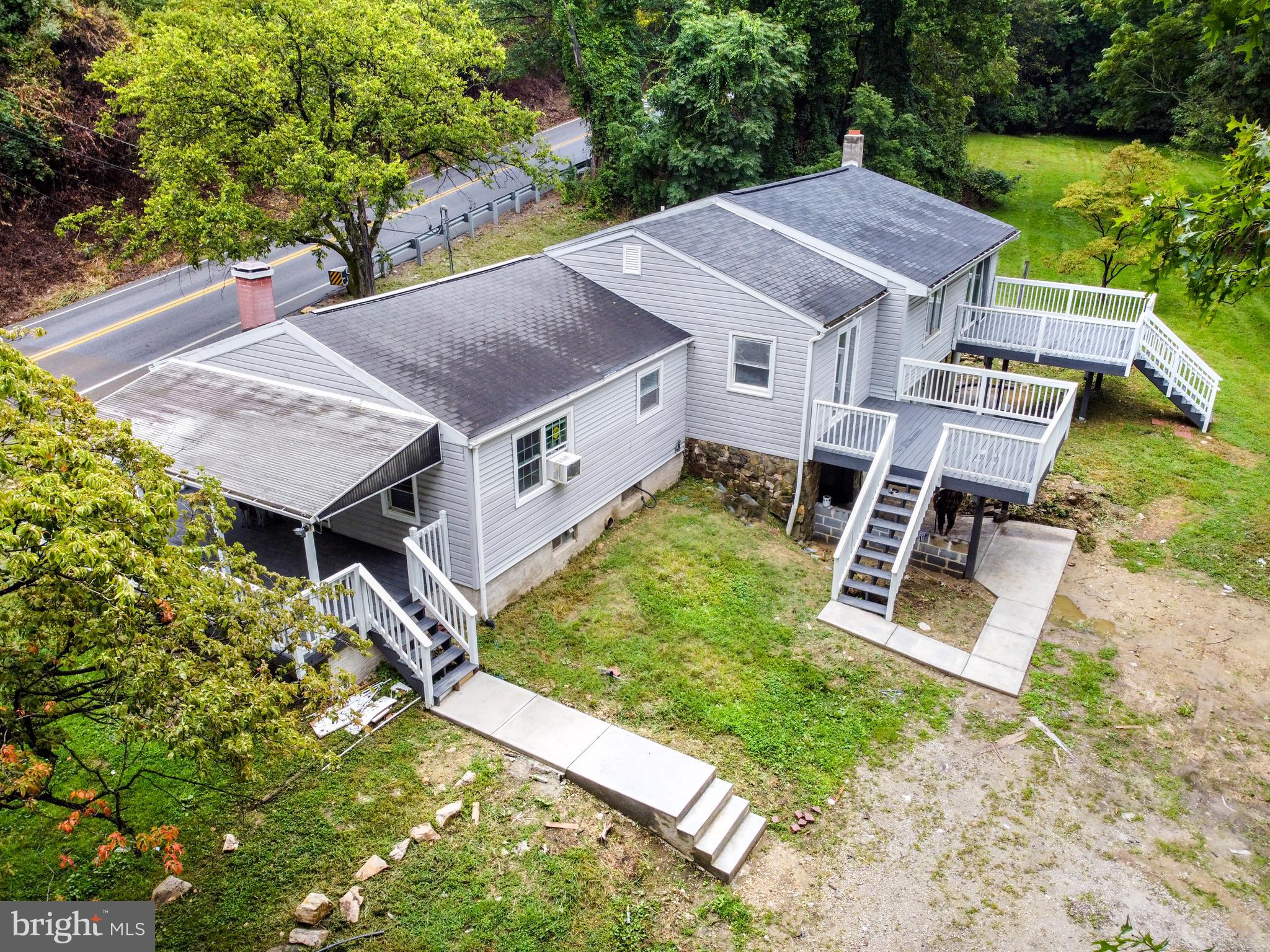 an aerial view of a house with a yard table and chairs