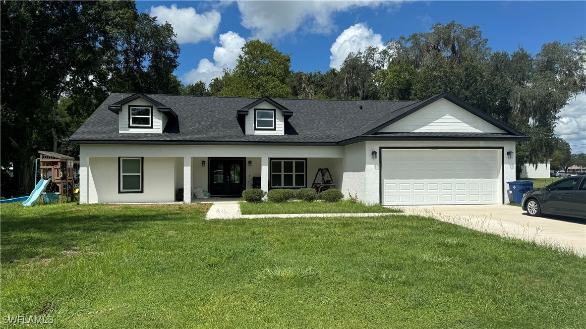 a front view of a house with a yard and garage