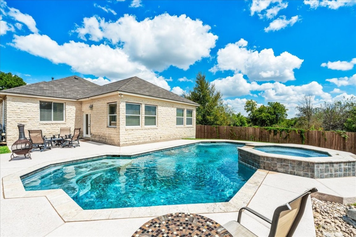 a view of a house with backyard sitting area and garden