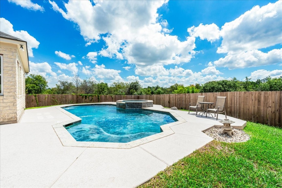 The backyard features a sparkling pool and spa.