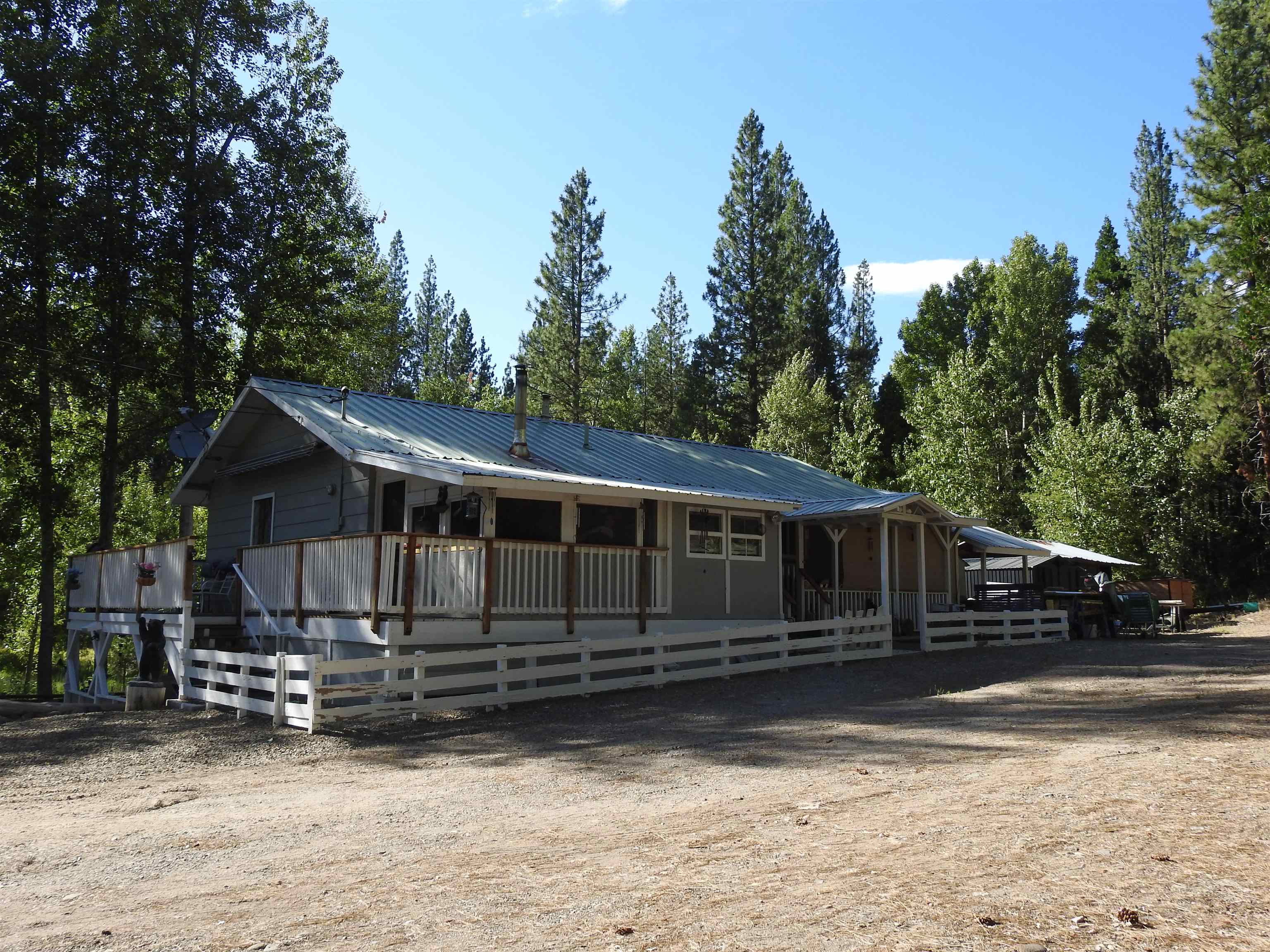 a view of a house with wooden fence