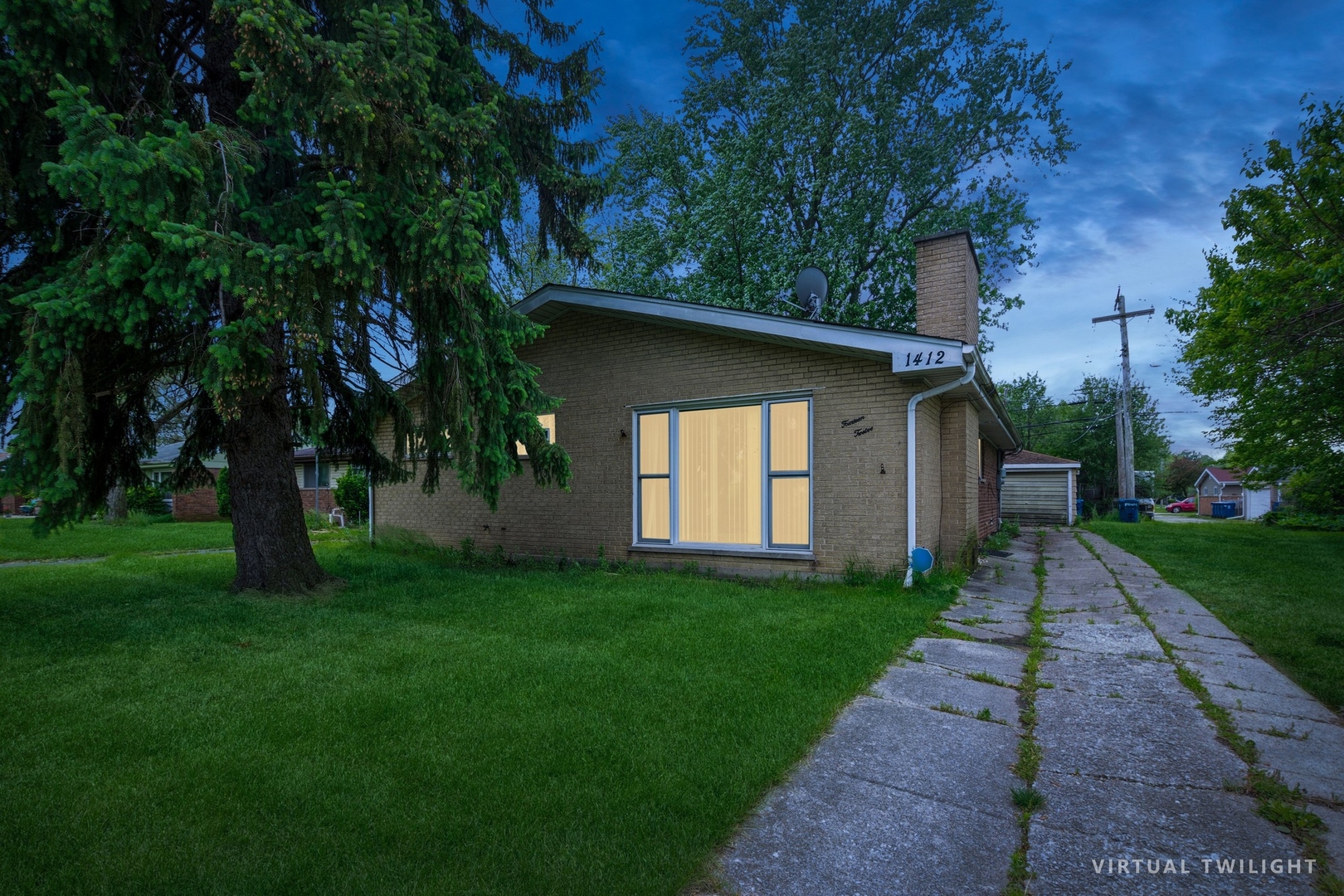 a view of a yard in front of a house with large trees