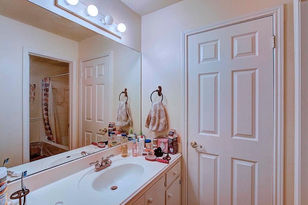 a bathroom with double vanity sink and a mirror