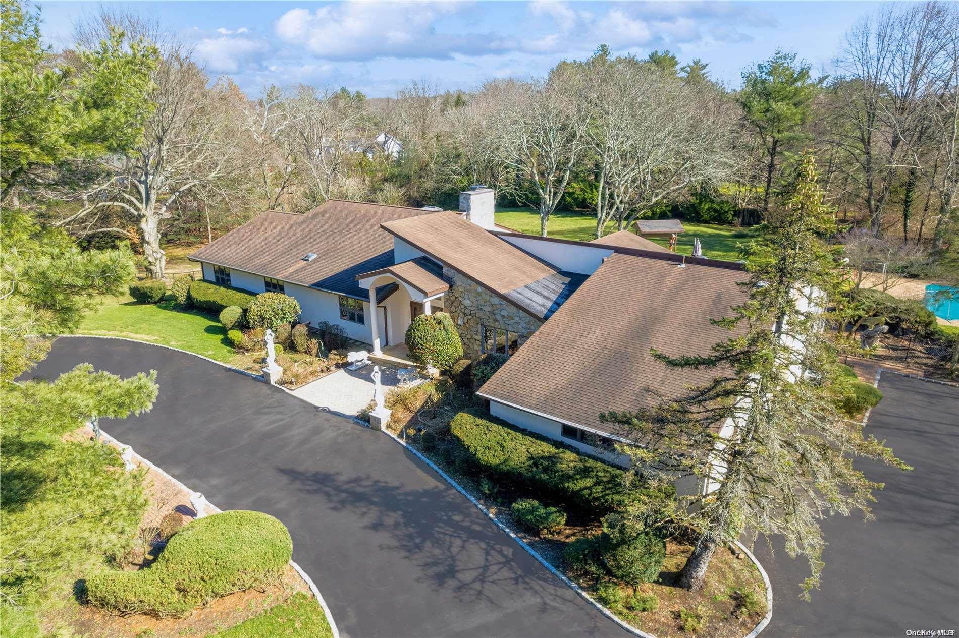 an aerial view of a house with a yard and lake view