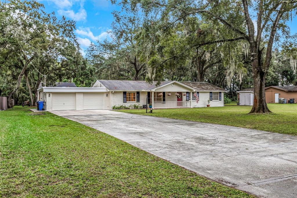 a front view of house with yard and green space