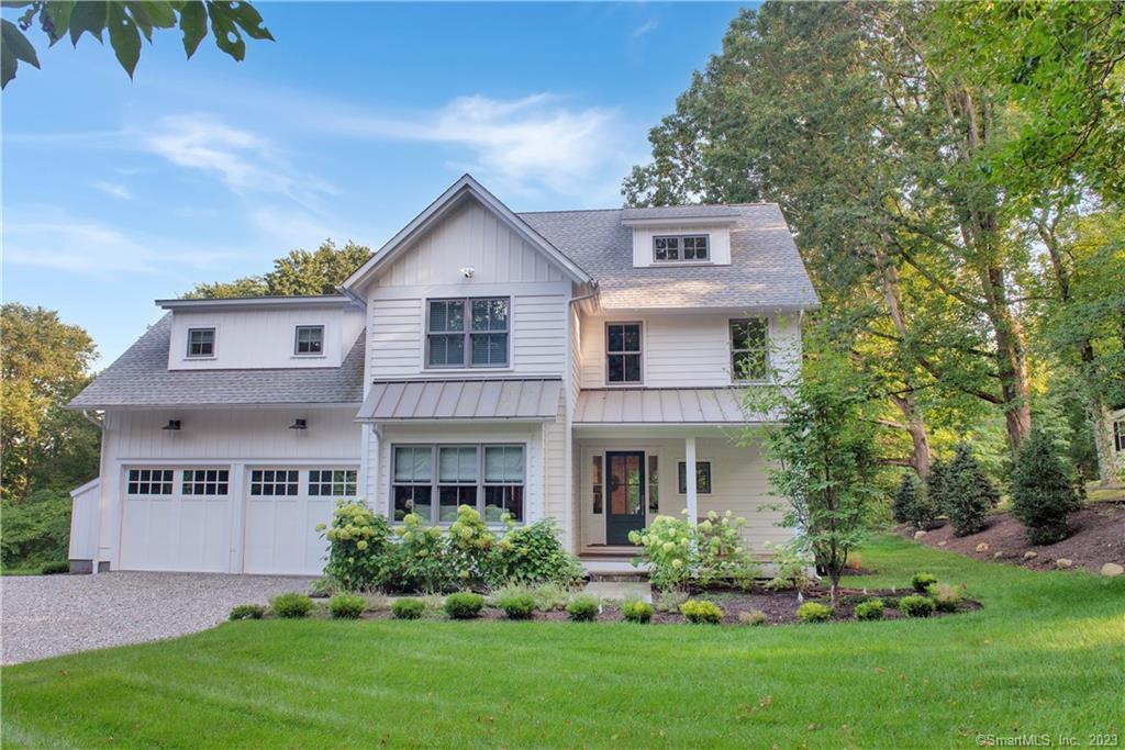 a front view of house with yard and green space