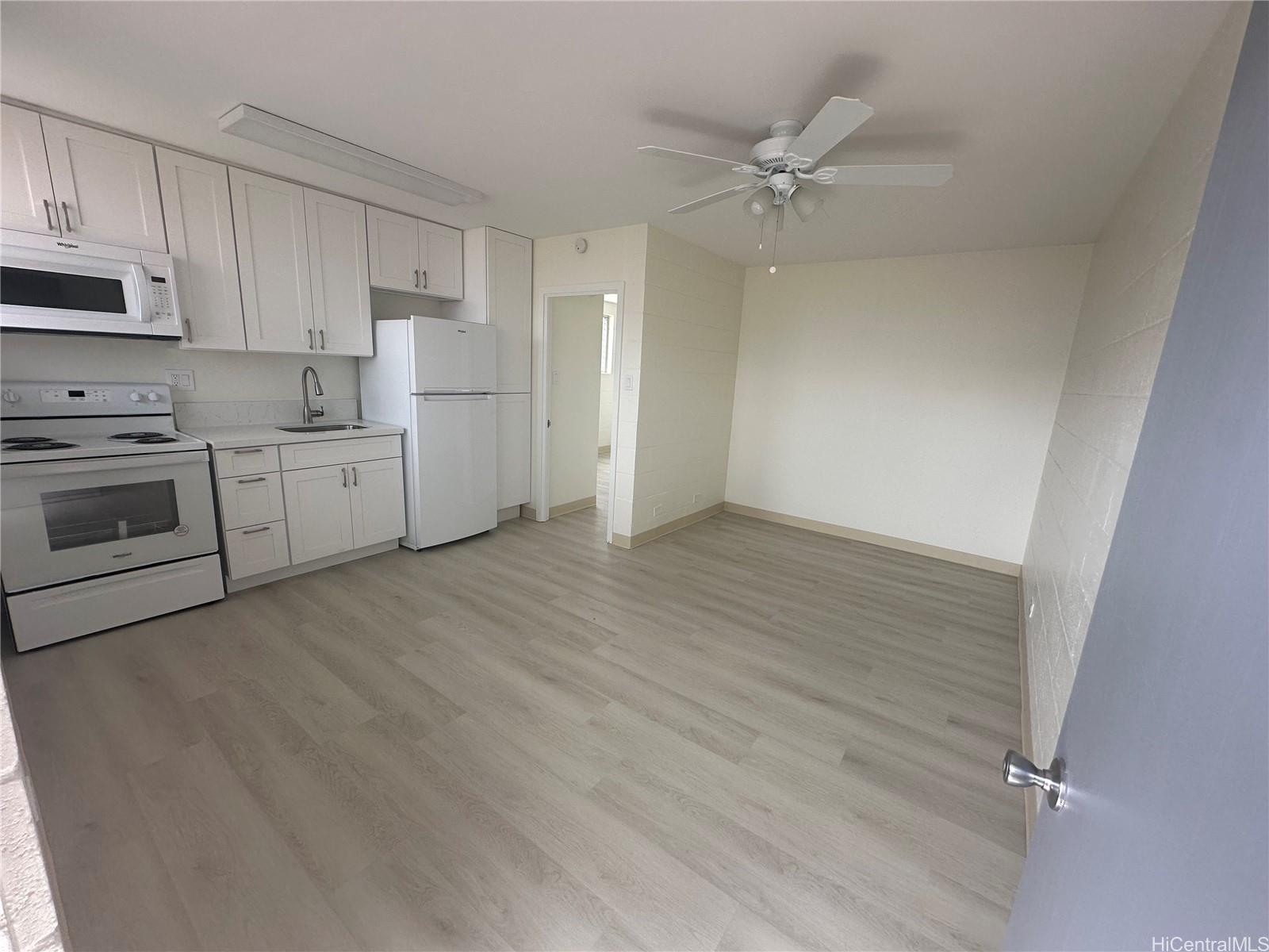 a open kitchen with cabinets stove and oven