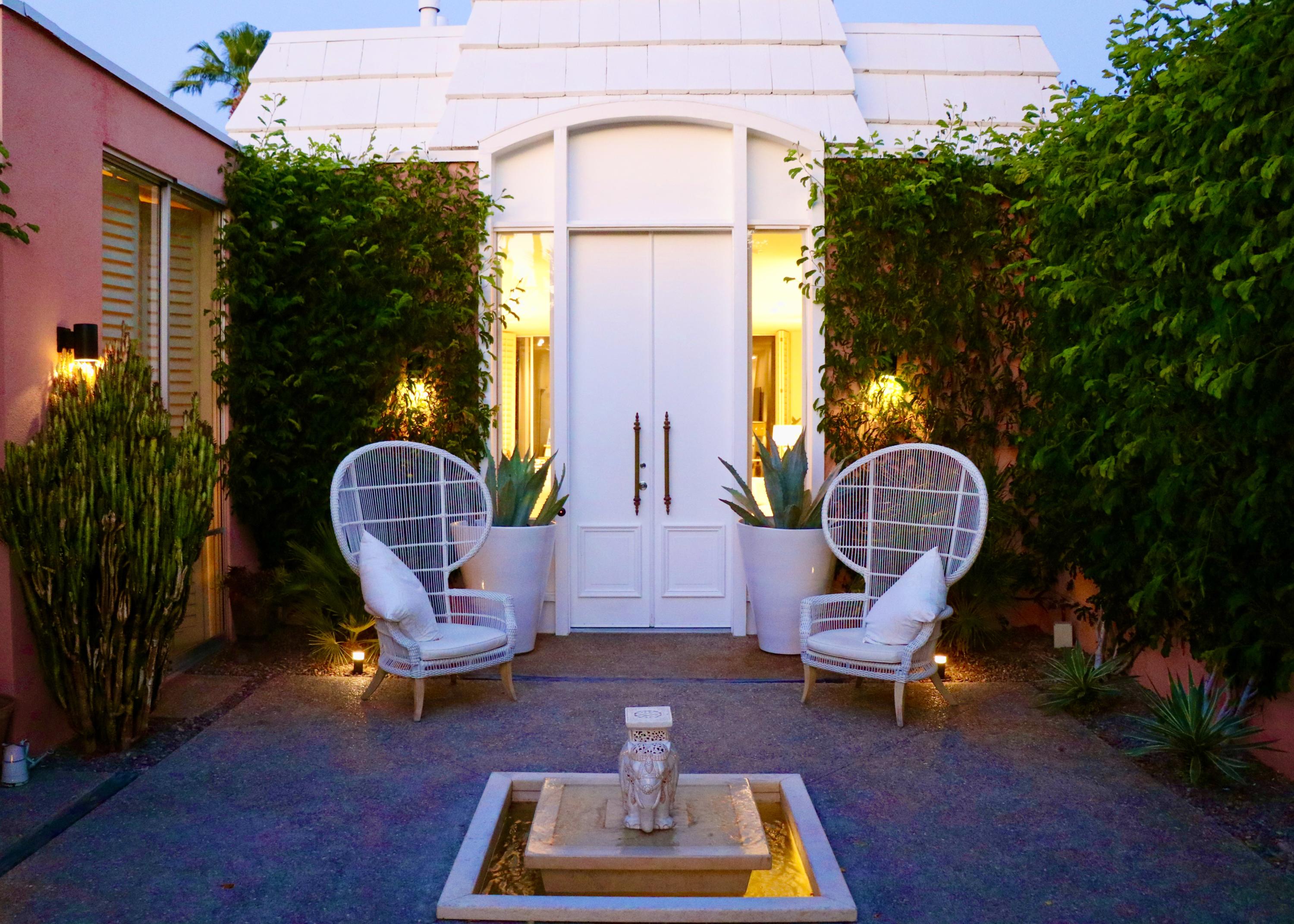 a view of a swimming pool with sitting area and garden