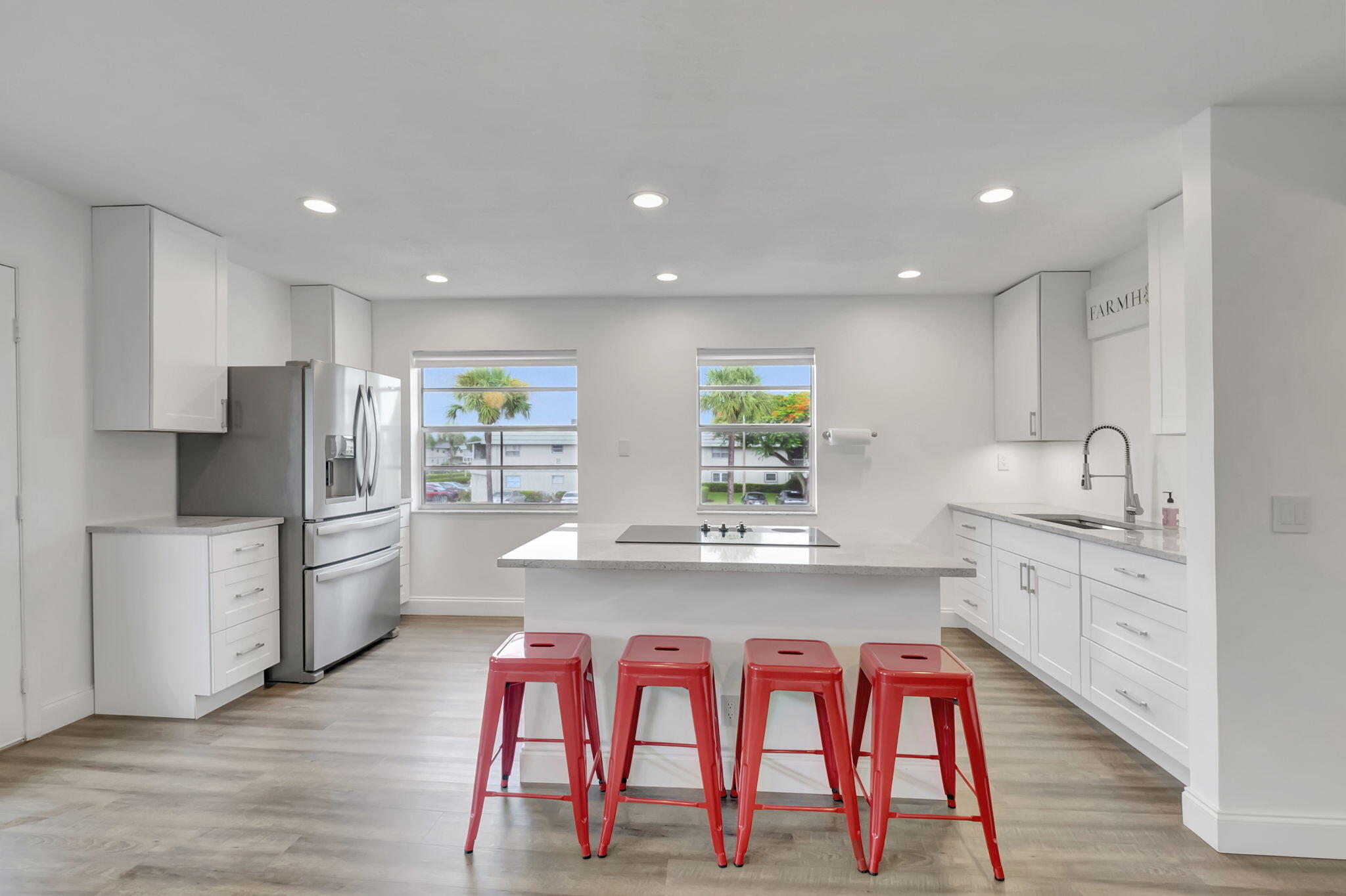 a kitchen with stainless steel appliances granite countertop white cabinets a sink and a stove