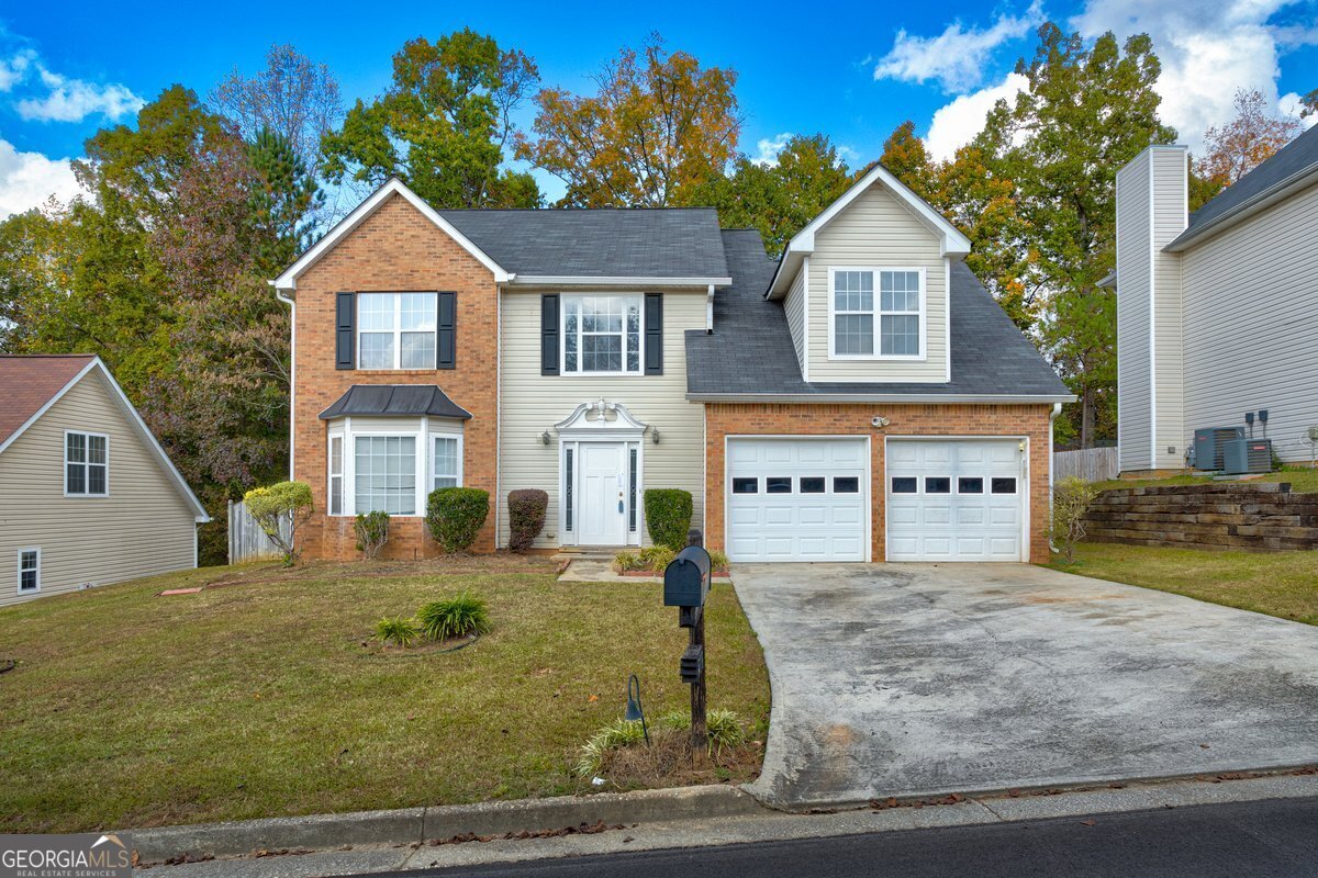 a front view of a house with a yard