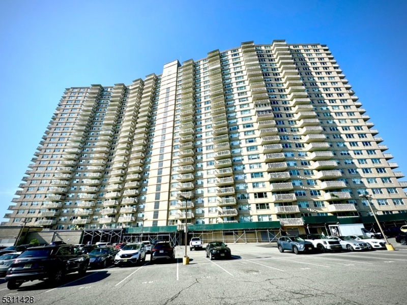 a front view of a building with parking