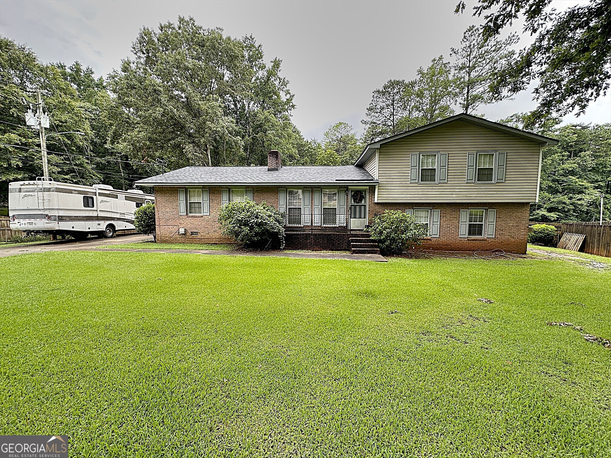 a front view of house with yard and green space