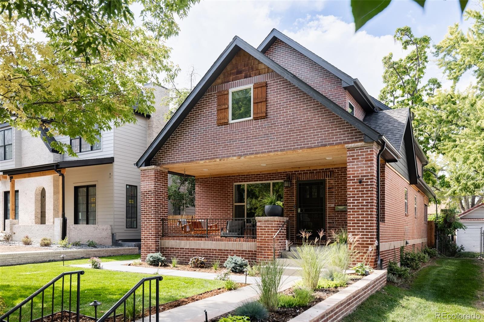 a view of house with swimming pool and furniture