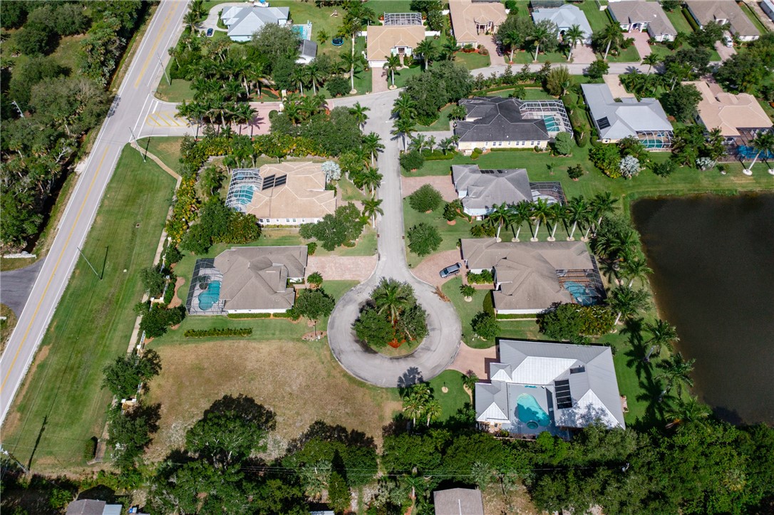 an aerial view of a house with garden space and street view