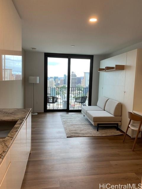 a living room with furniture and a floor to ceiling window