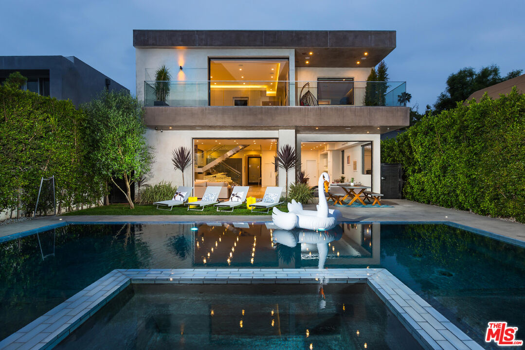 a front view of house with yard and outdoor seating