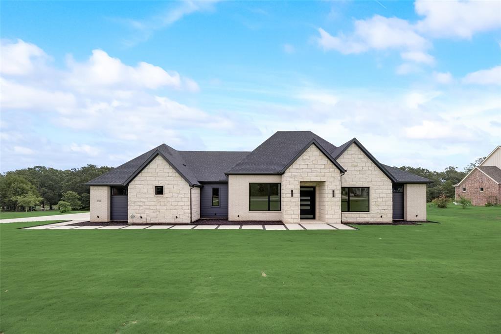 a front view of house with yard and green space