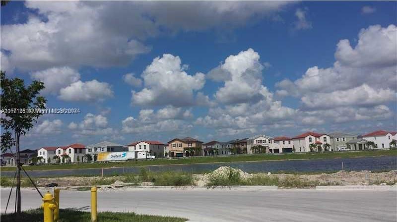 a view of a lake with a houses in the background