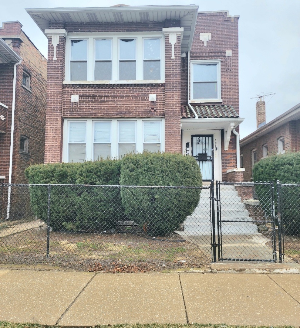 a view of a brick house next to a road