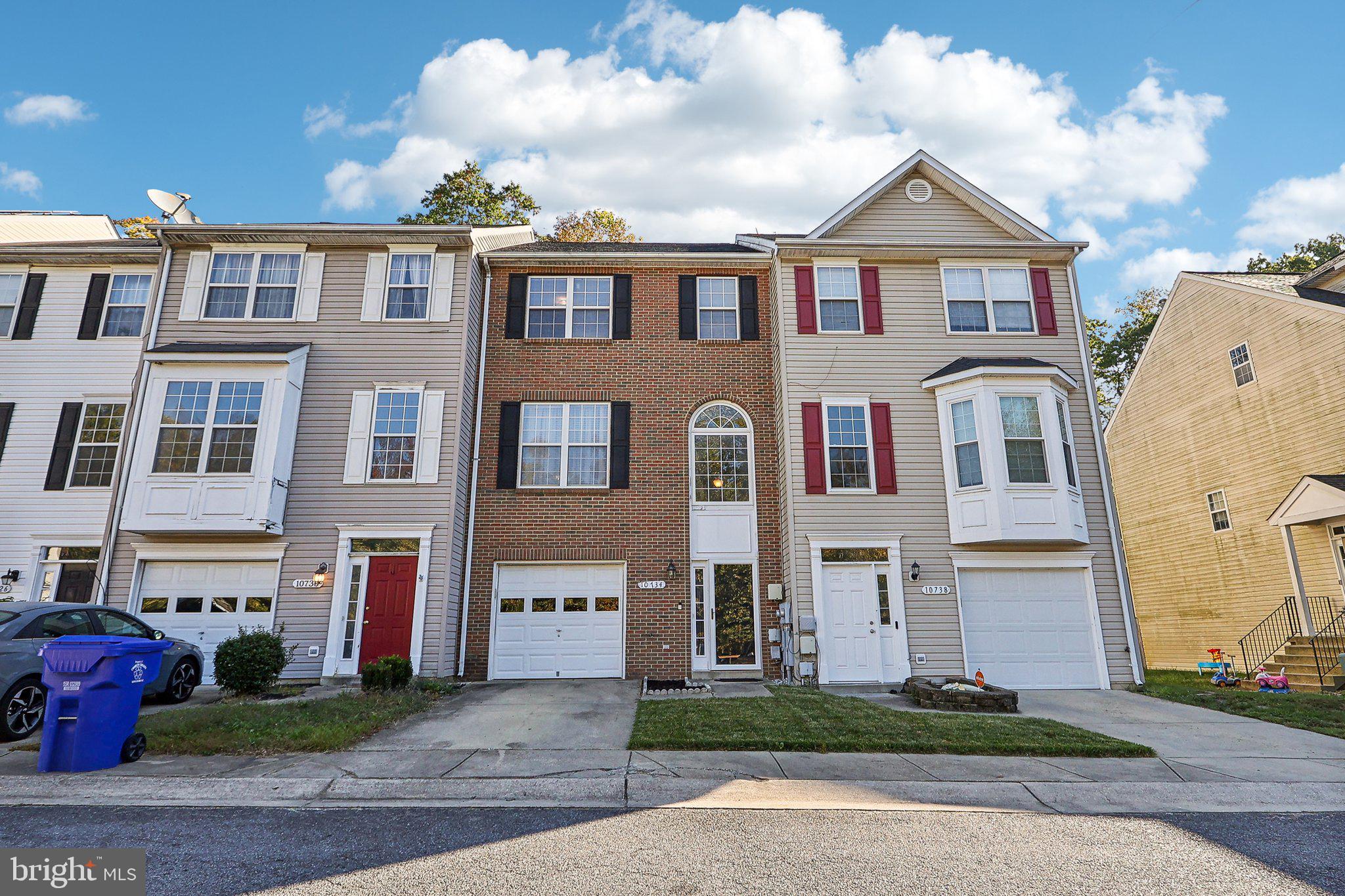 a front view of a residential houses with yard