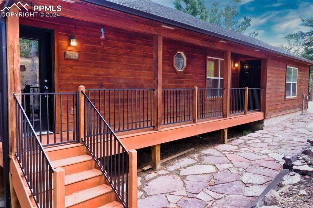 a view of backyard with deck and wooden floor