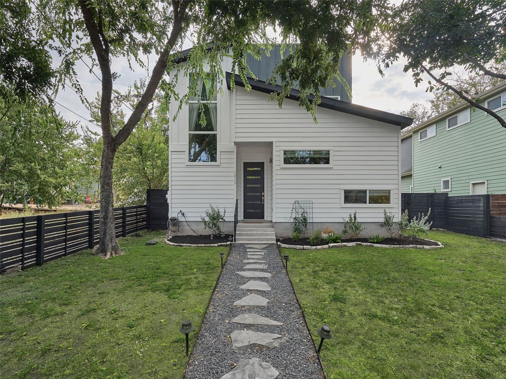 a front view of a house with garden