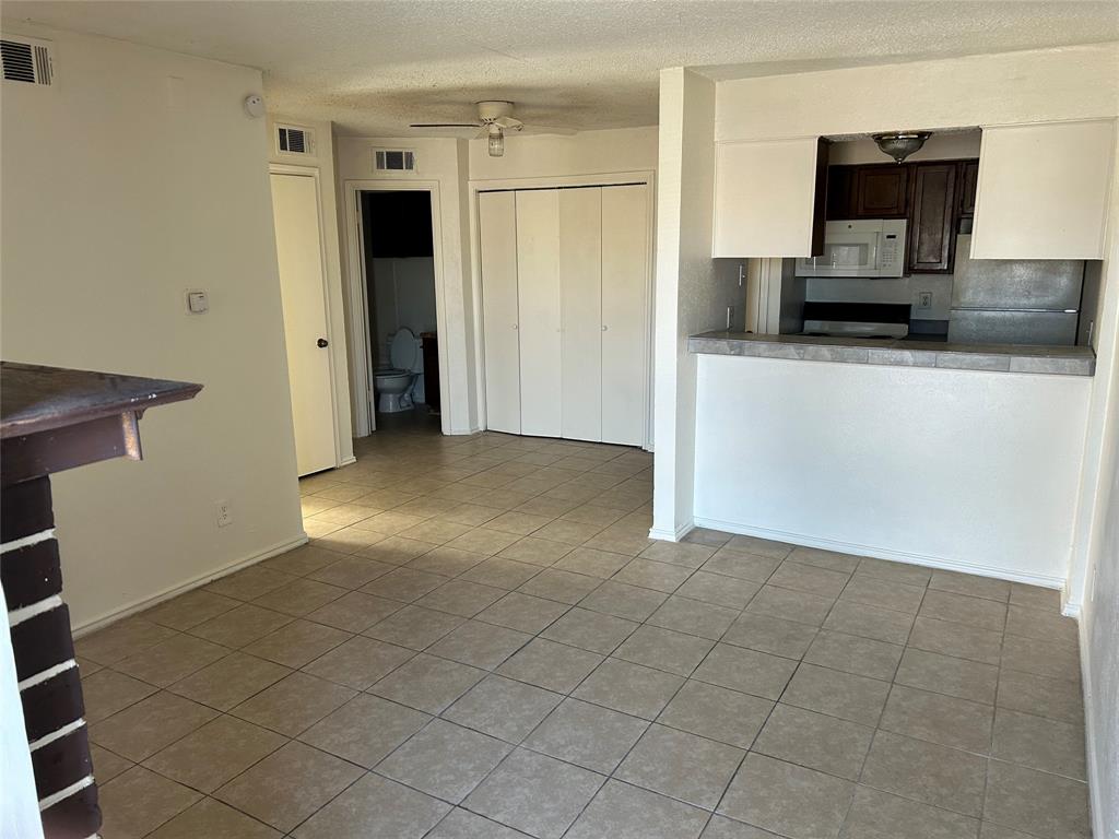 a view of a livingroom with a kitchen