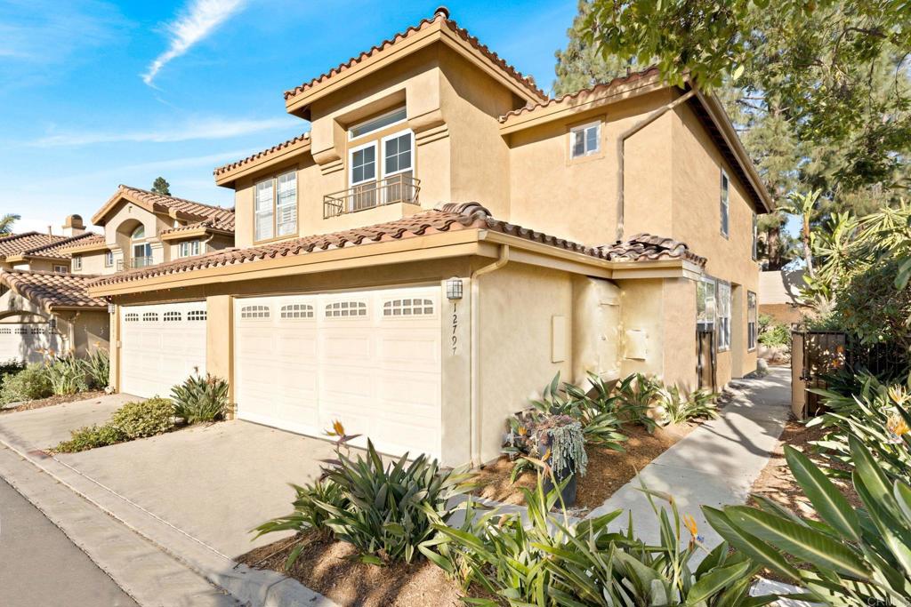 a front view of a house with a yard and a garage