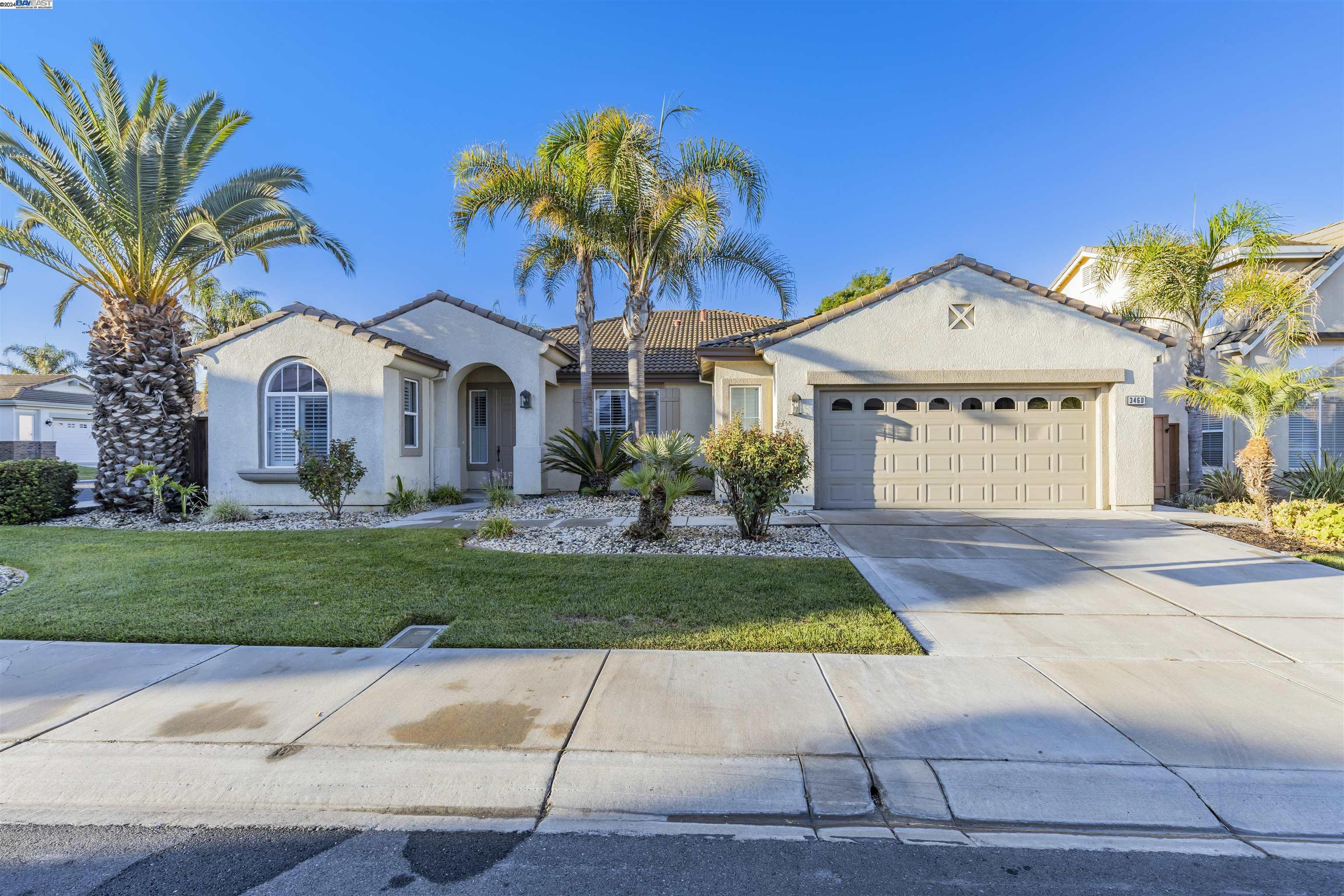 a front view of a house with a yard and a garage