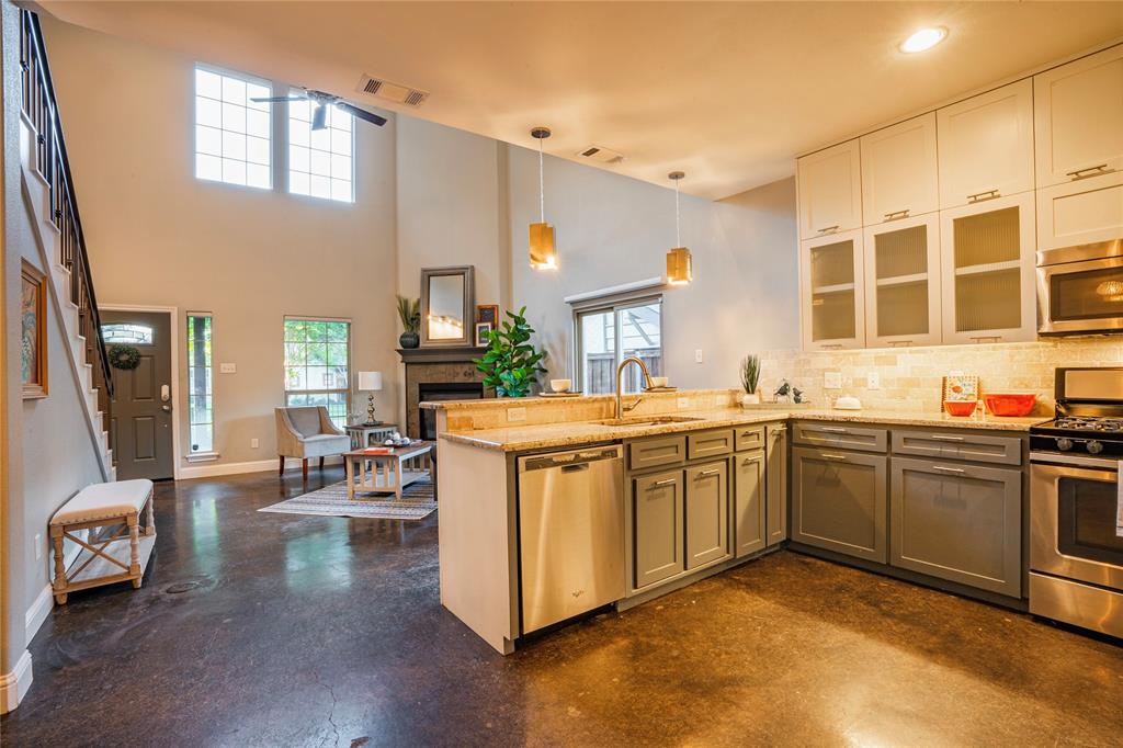 a kitchen with stainless steel appliances granite countertop a stove and cabinets