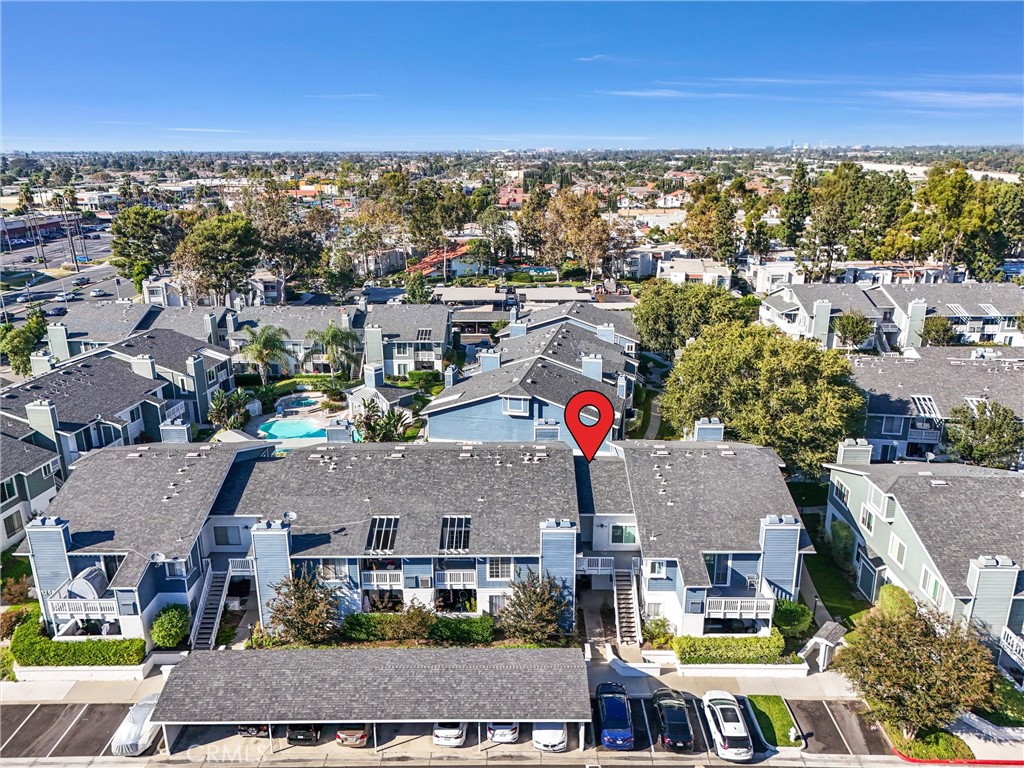 an aerial view of residential houses with outdoor space and ocean view