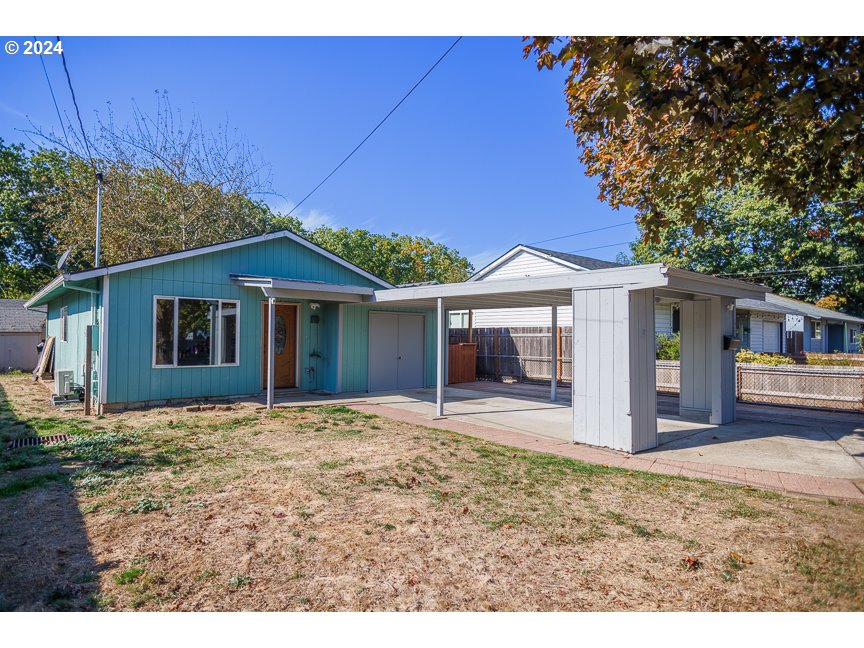 a view of a house with a patio and a yard