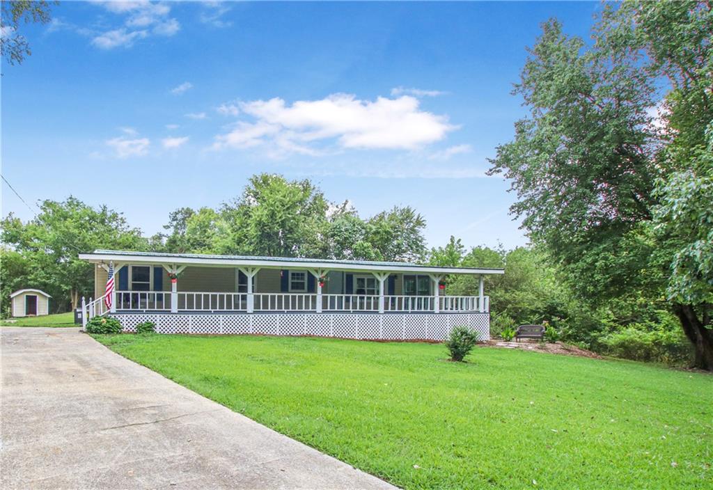 a view of a house with backyard and sitting area