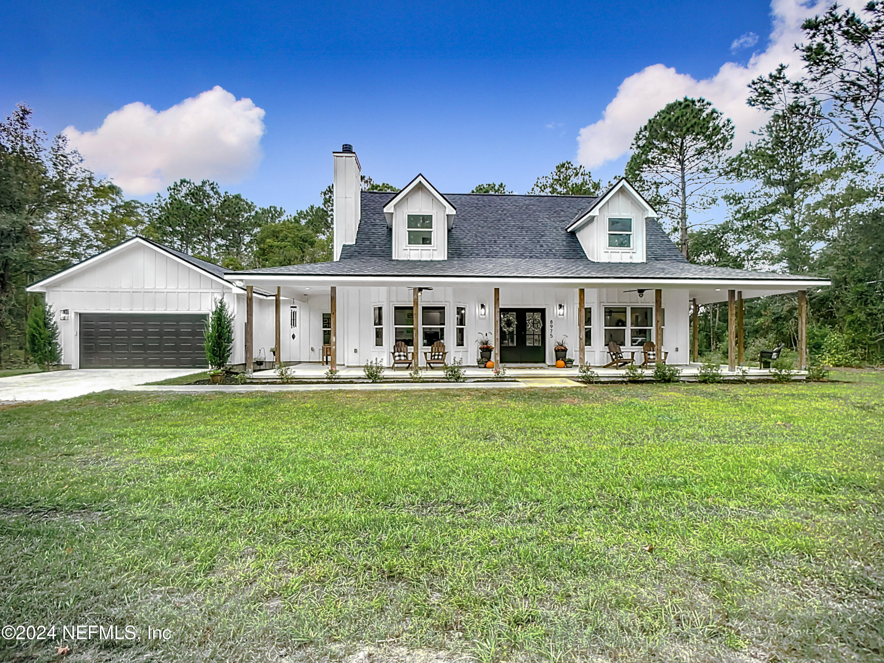 a front view of a house with a garden