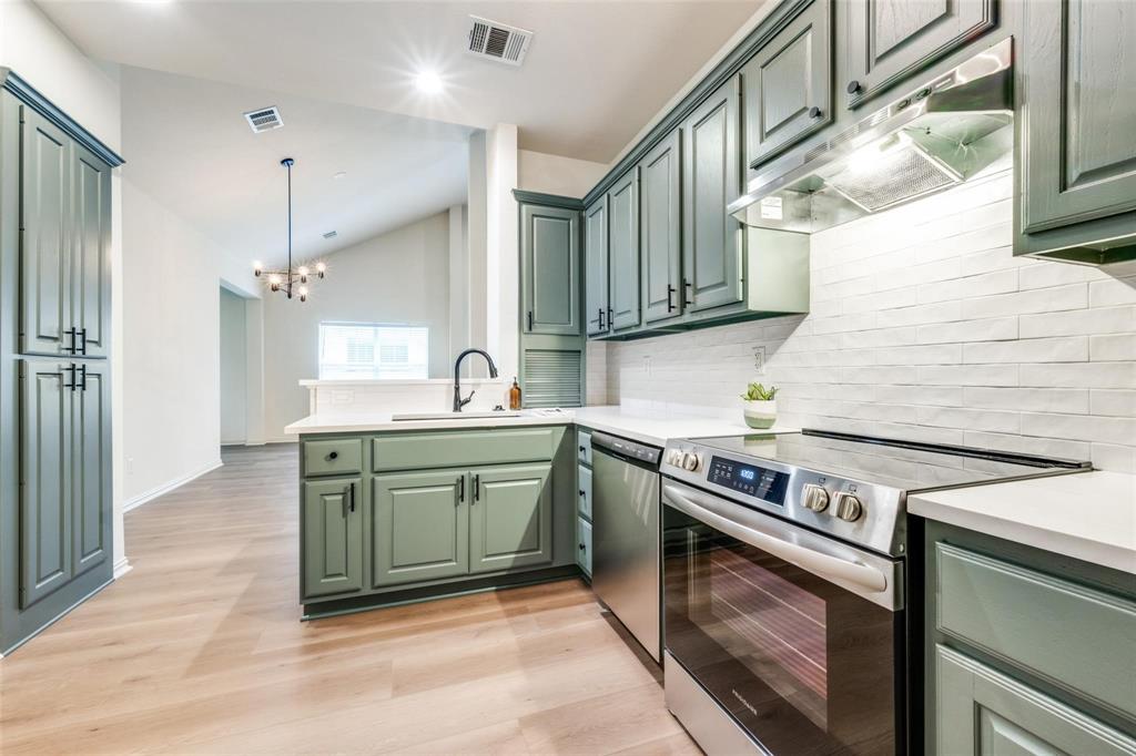 a kitchen with a stove and a sink