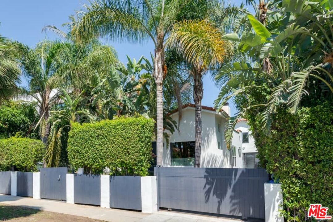 front view of a house with a tree