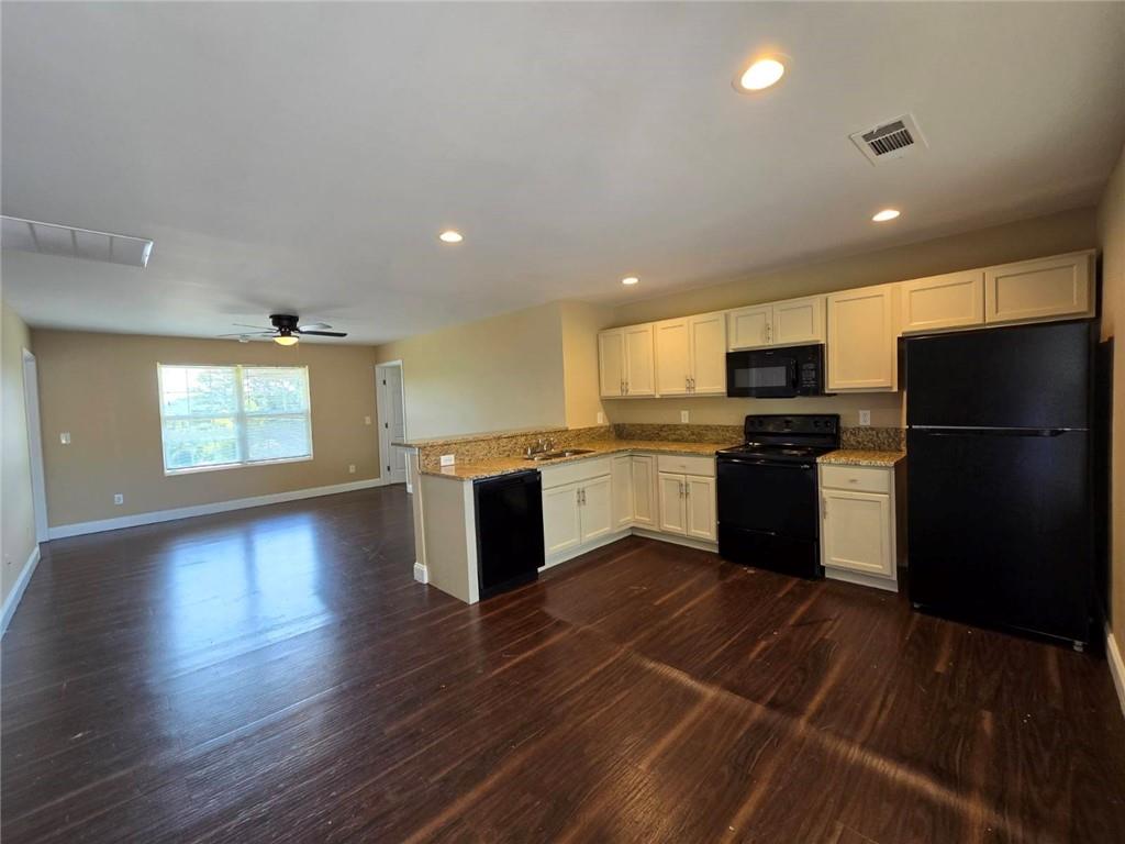 a kitchen with a refrigerator and a stove top oven