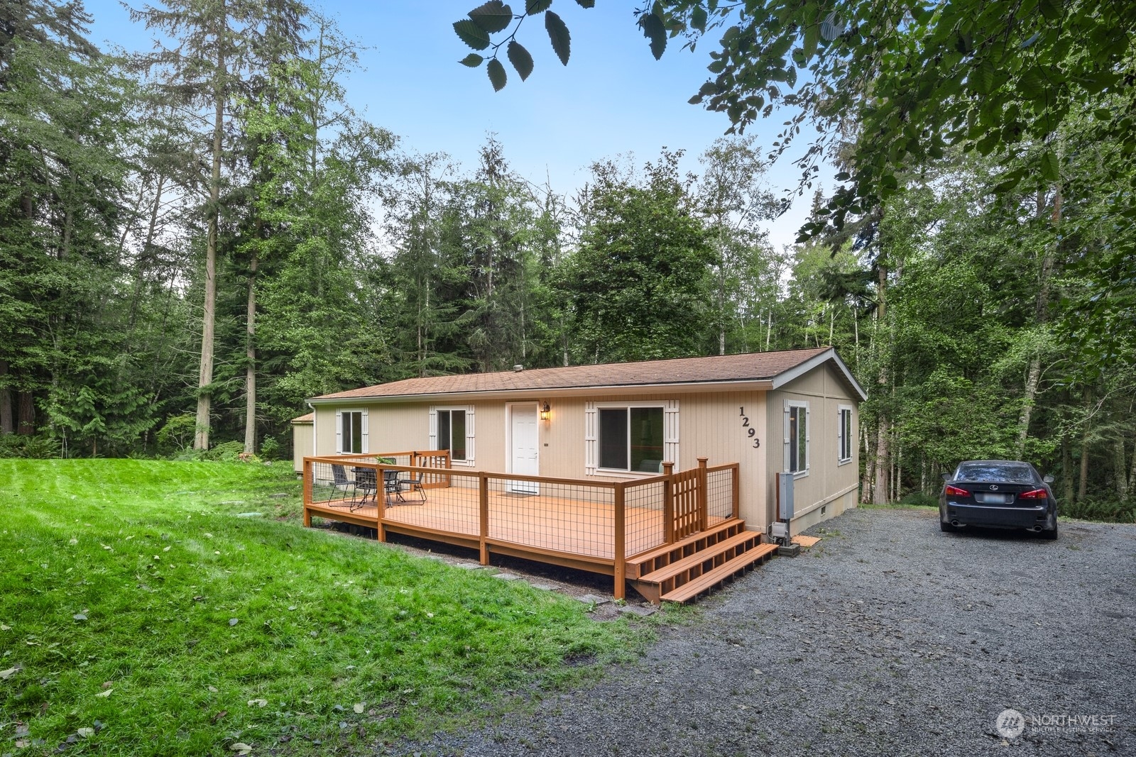 a view of a house with a backyard and sitting area