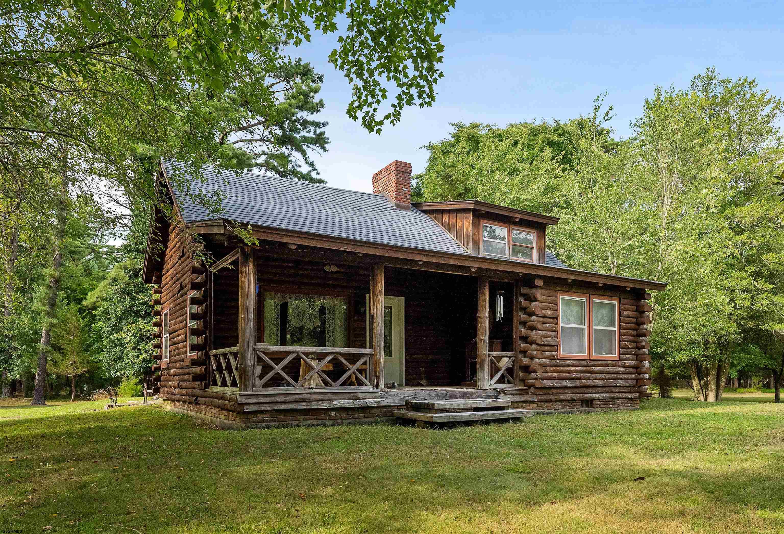 a view of a house with backyard porch and sitting area