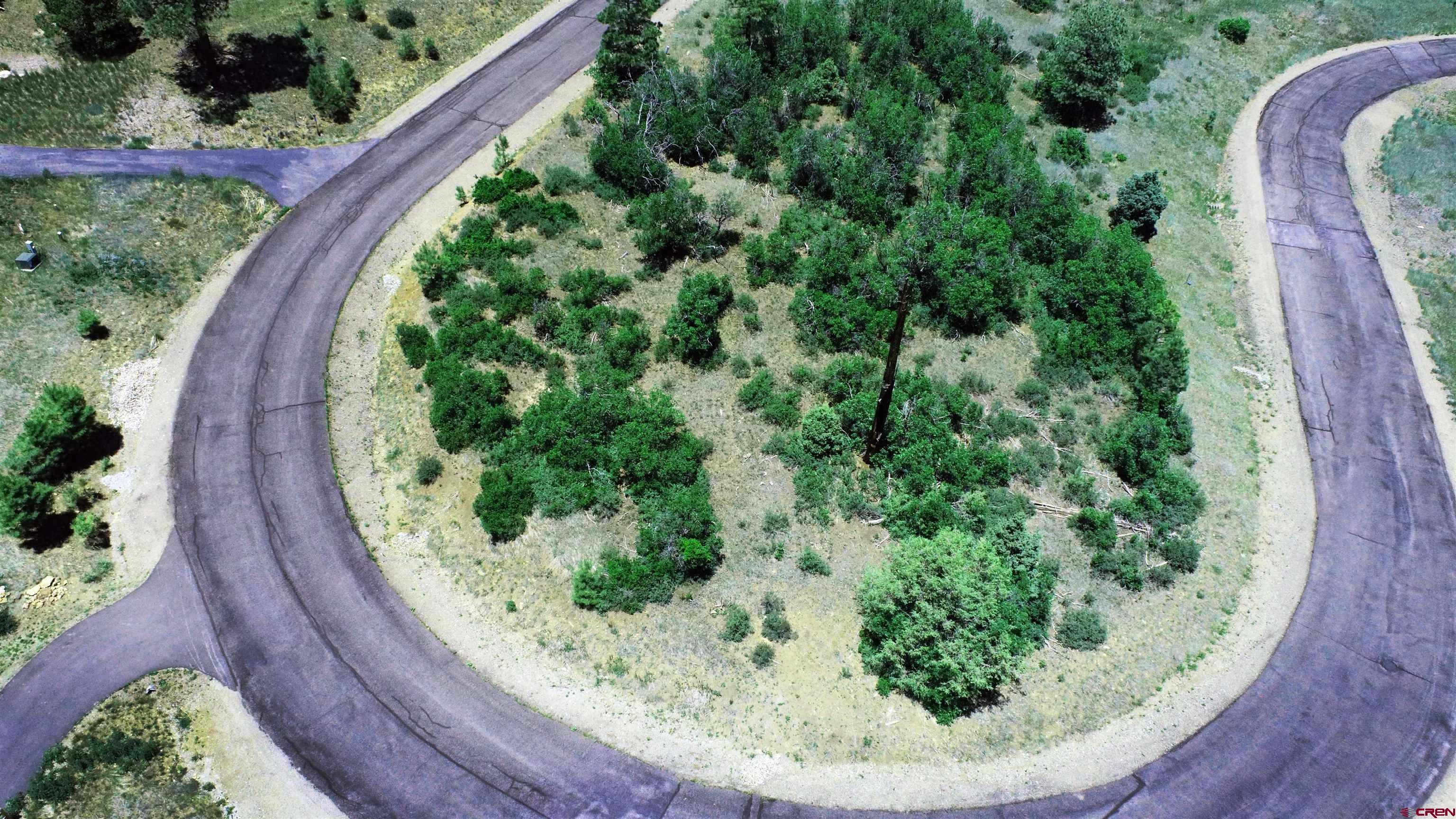 an aerial view of a wooden house with a garden