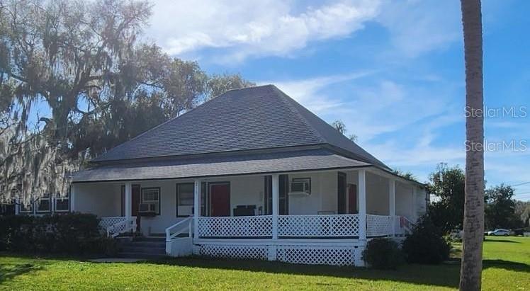 a view of house with a yard