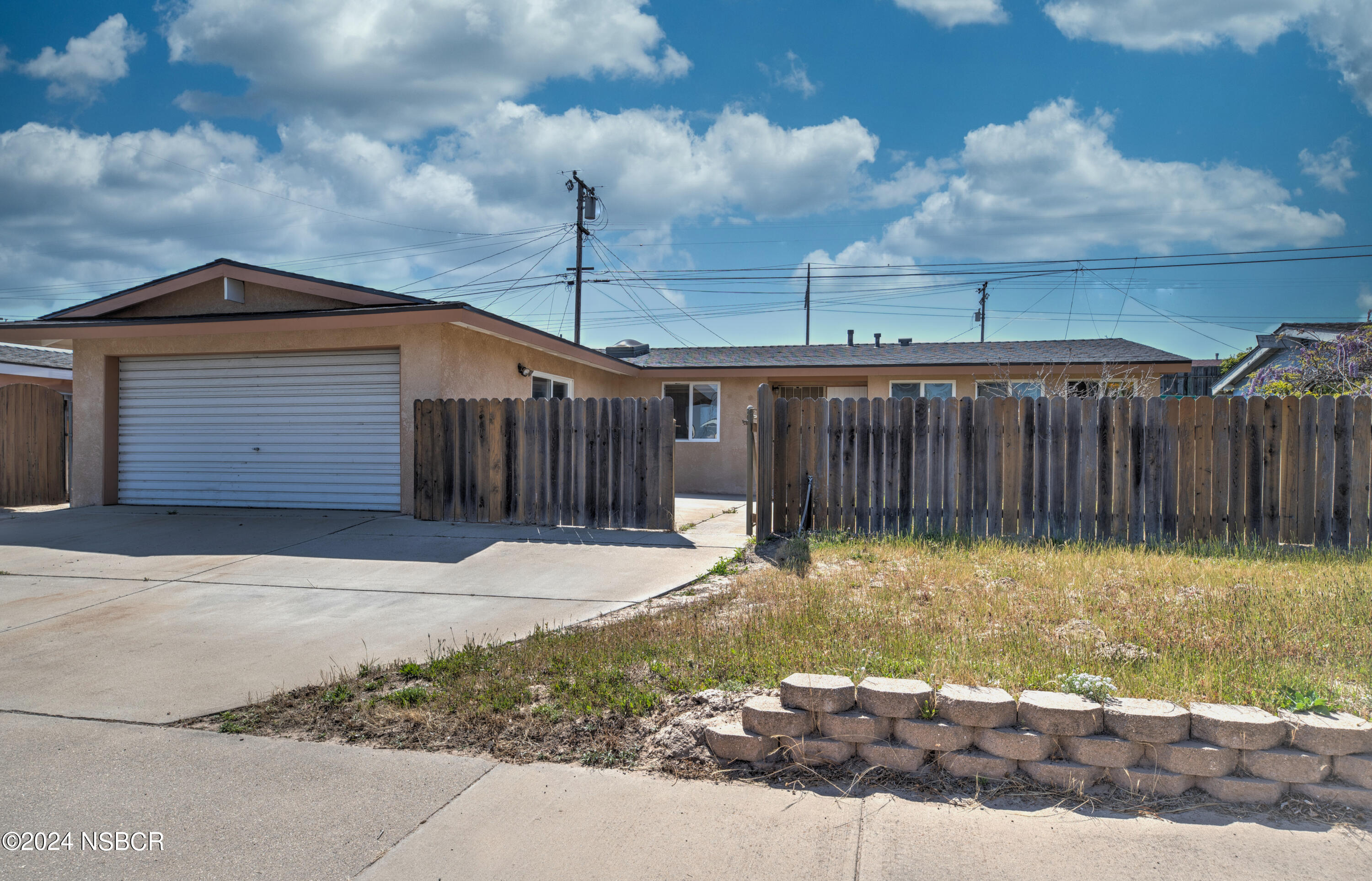 a backyard of a house with wooden fence