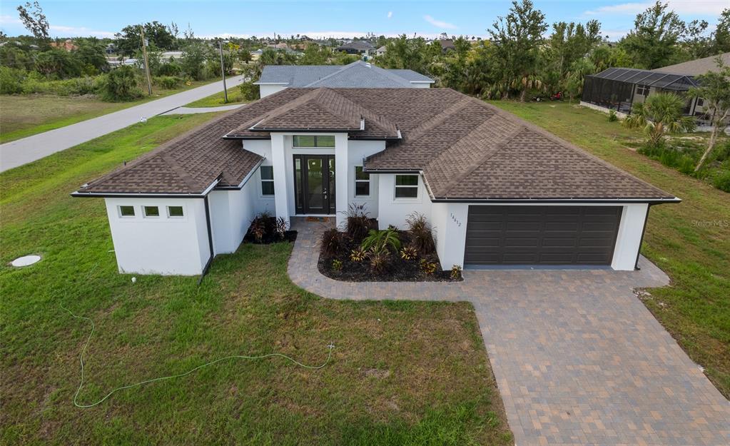 a aerial view of a house with a yard and garage