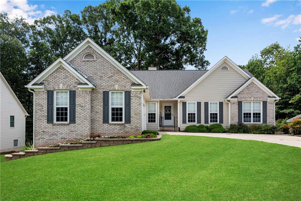 a front view of a house with a yard and garage