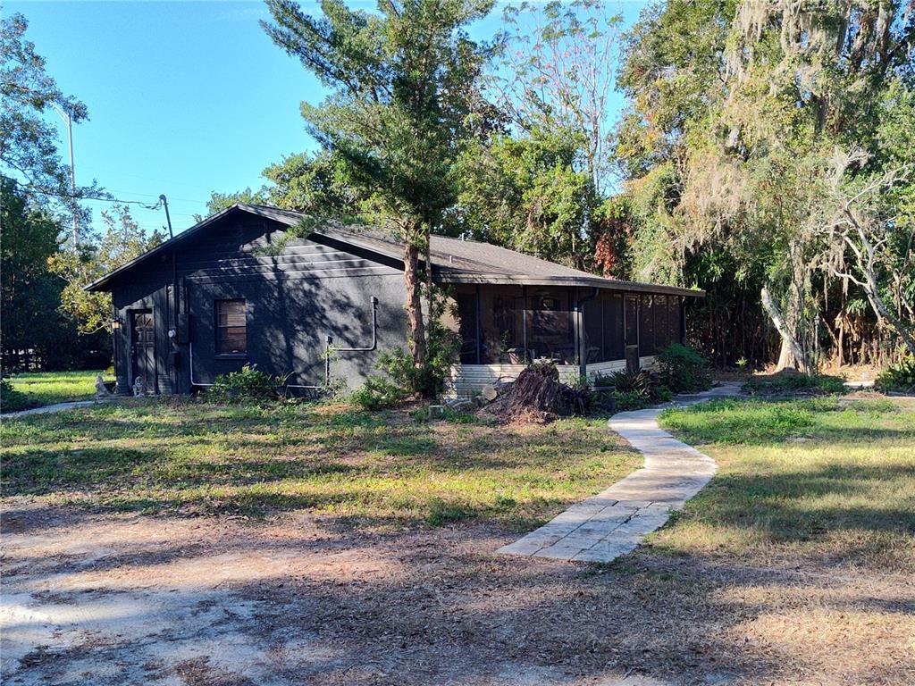 a view of a house with backyard and sitting area