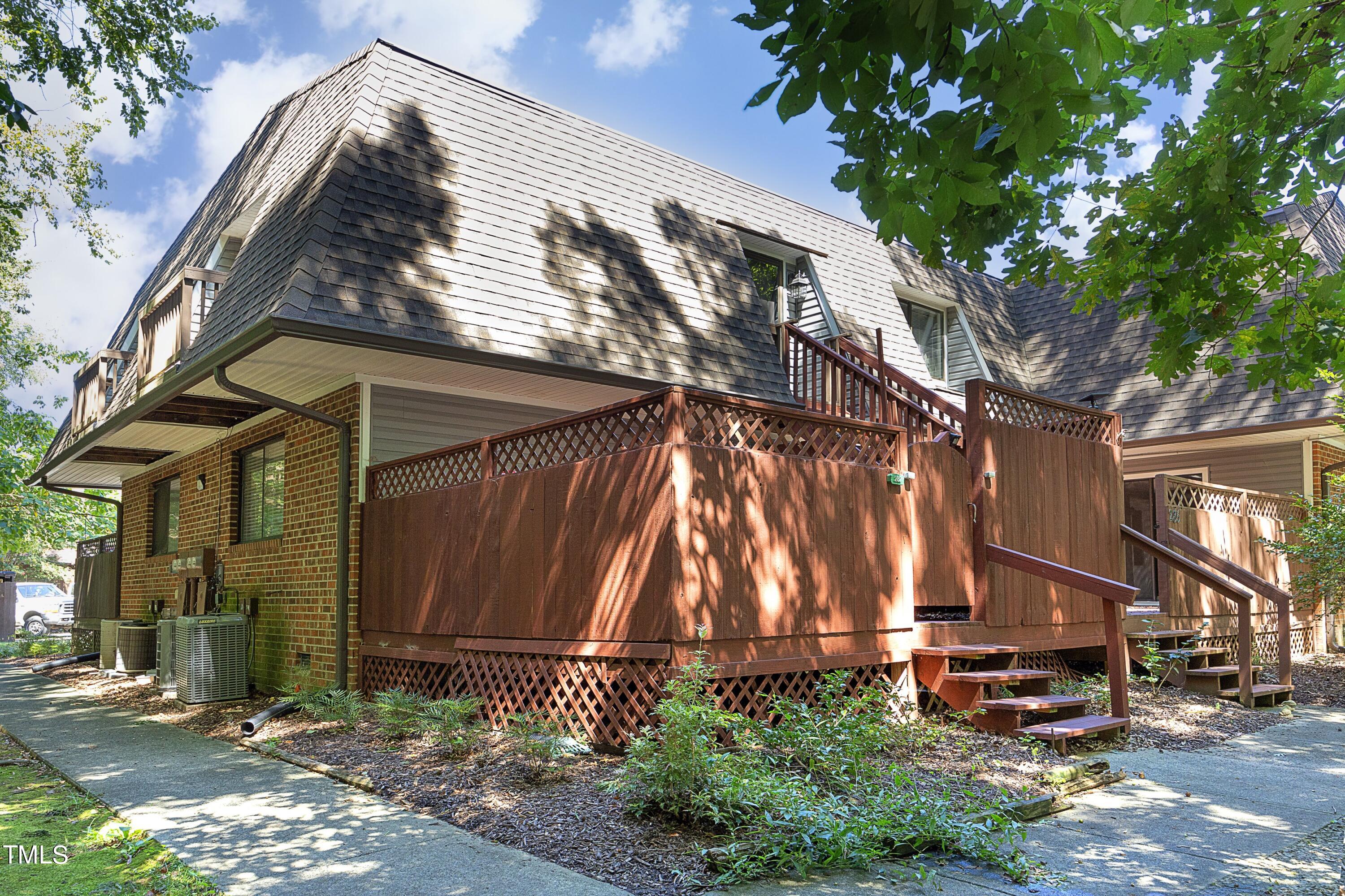 a backyard of a house with outdoor seating and trees