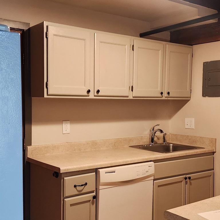 a kitchen with appliances cabinets and a sink