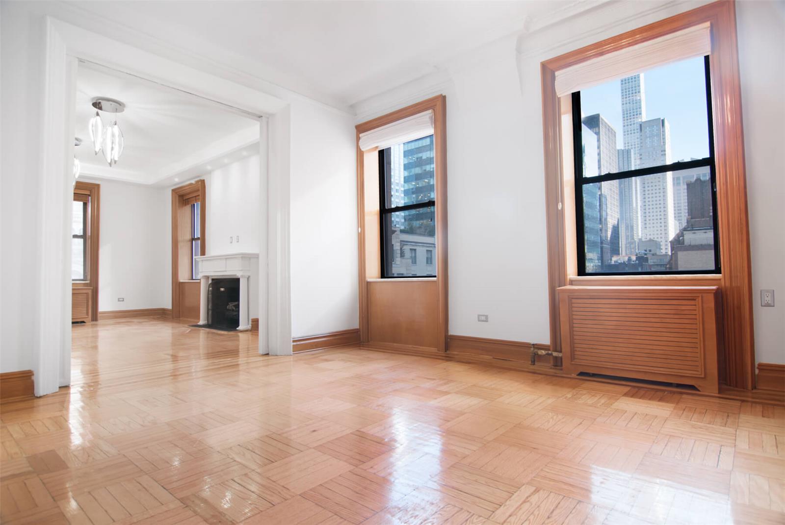 a view of an empty room with window and cabinet